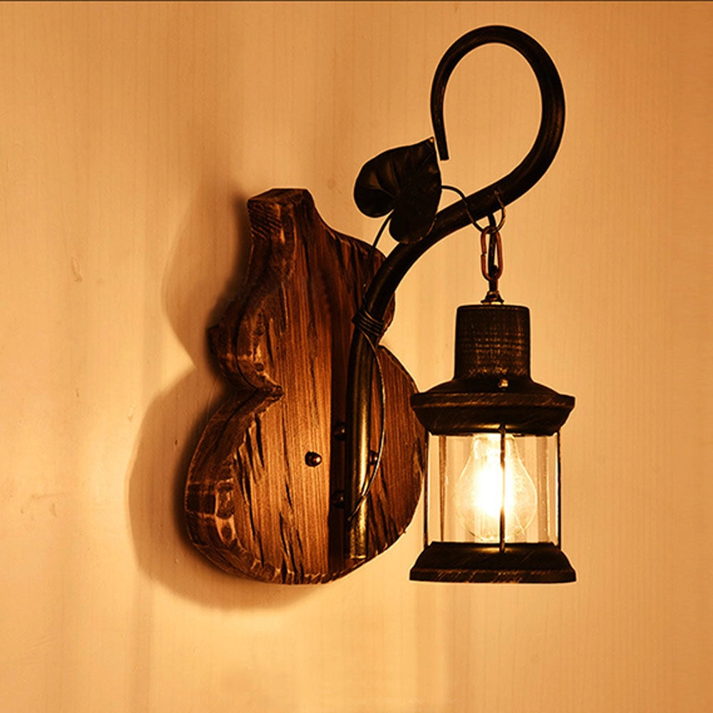 Vintage rustic wall lantern featuring an antique design with metal and wood elements, emitting an amber glow and serving as a decorative sconce.