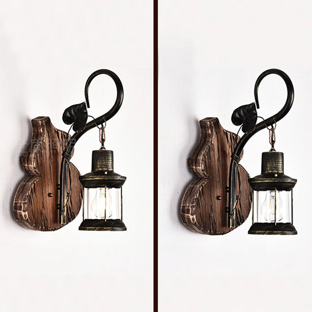 Vintage rustic wall lantern made of antique metal and wood, featuring a sconce design, displayed in a still life setting.