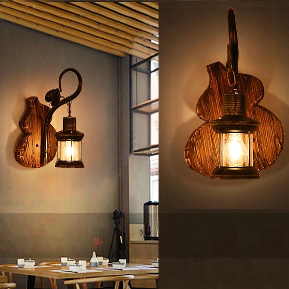 Vintage rustic wall lantern featuring antique metal and wood sconce design, illuminated with an amber glow, enhancing interior decor with its unique architectural style.