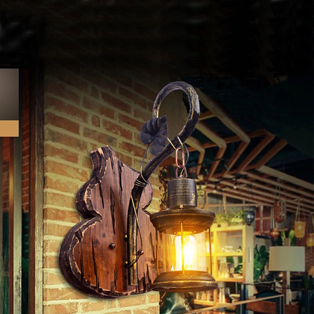 Vintage rustic wall lantern featuring an antique metal and wood design, with a glass pane creating a classic sconce decor.
