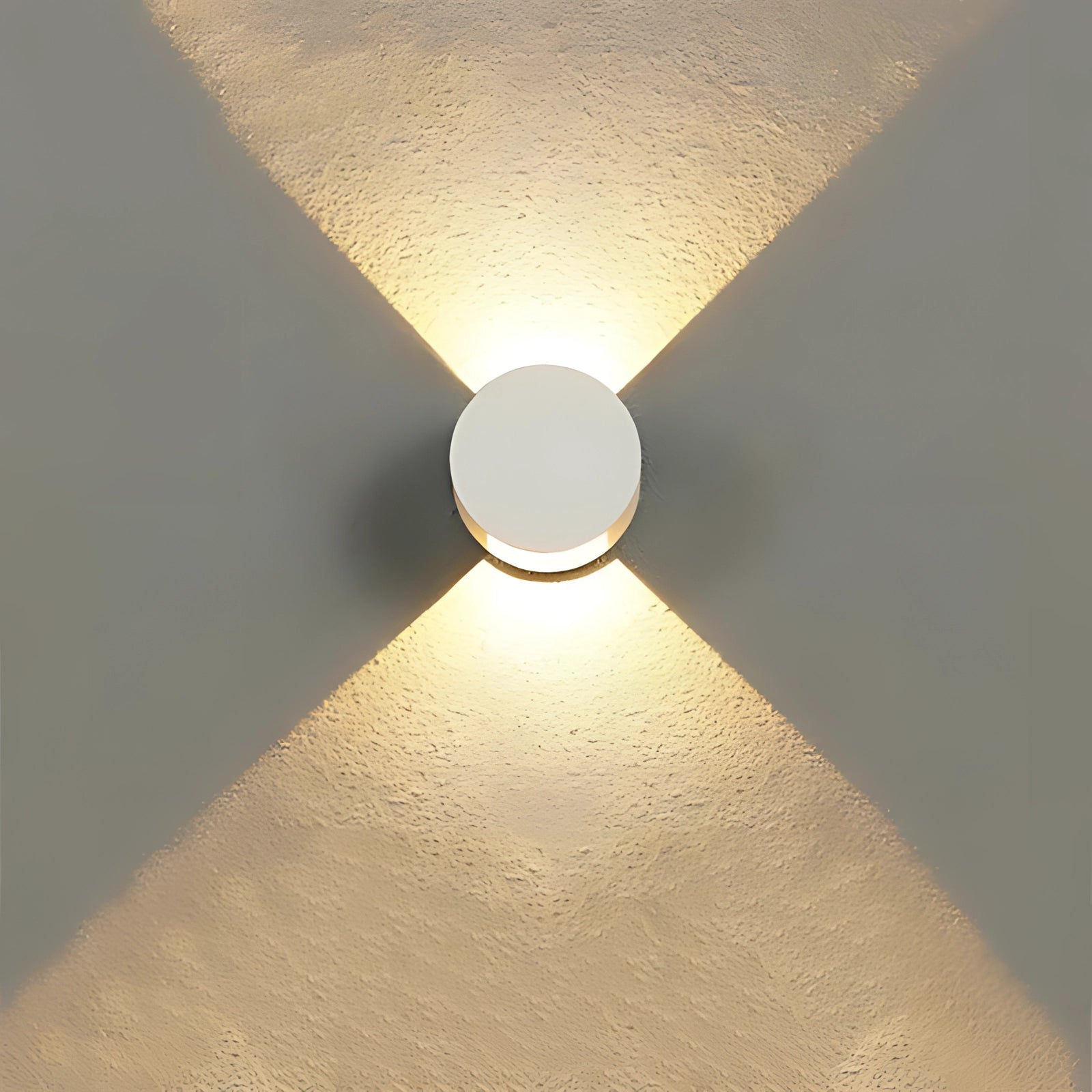 Modern minimalist waterproof LED outdoor wall sconce with a cool white glow, featuring a sleek white finish and circular amber-tinted shade, mounted on a wooden surface, showcasing symmetry and pattern in the design.