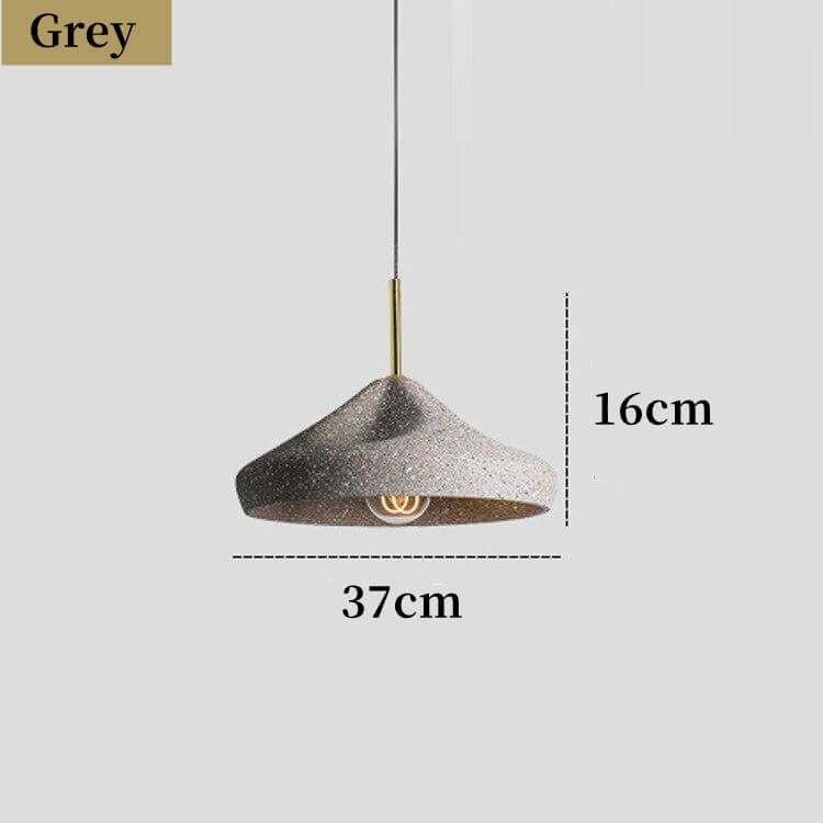 Industrial-style concrete pendant lights hanging over a kitchen island, showcasing minimalist design and modern elegance in a Nordic cement finish.