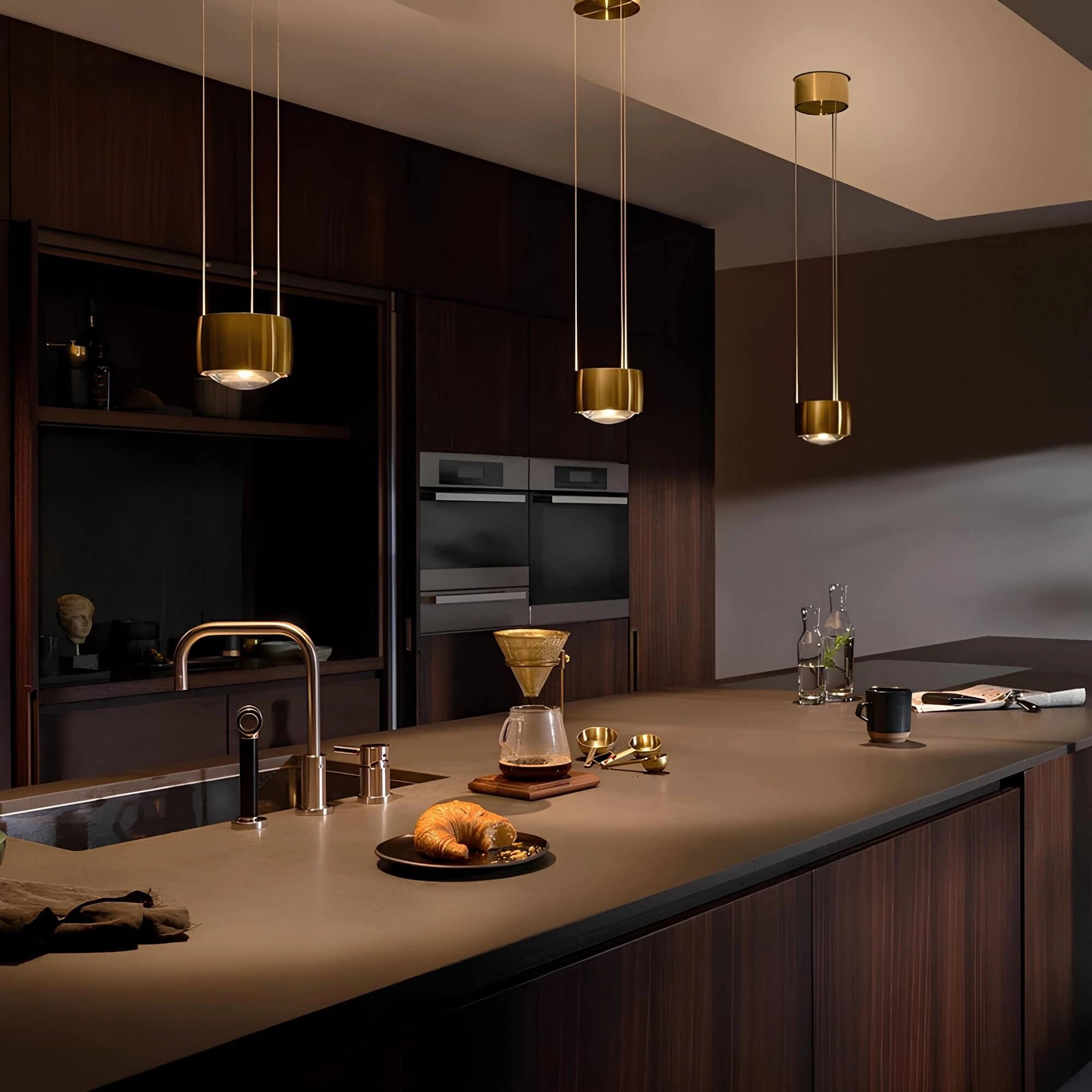 Modern kitchen interior featuring a 10W LED pendant light in black, hanging from the ceiling. The sleek and adjustable lamp illuminates a contemporary kitchen setup with light wood cabinetry, a polished countertop, and stainless steel tap fixtures. The scene is complemented by minimalist tableware, showcasing a harmonious blend of functional design and modern aesthetics.