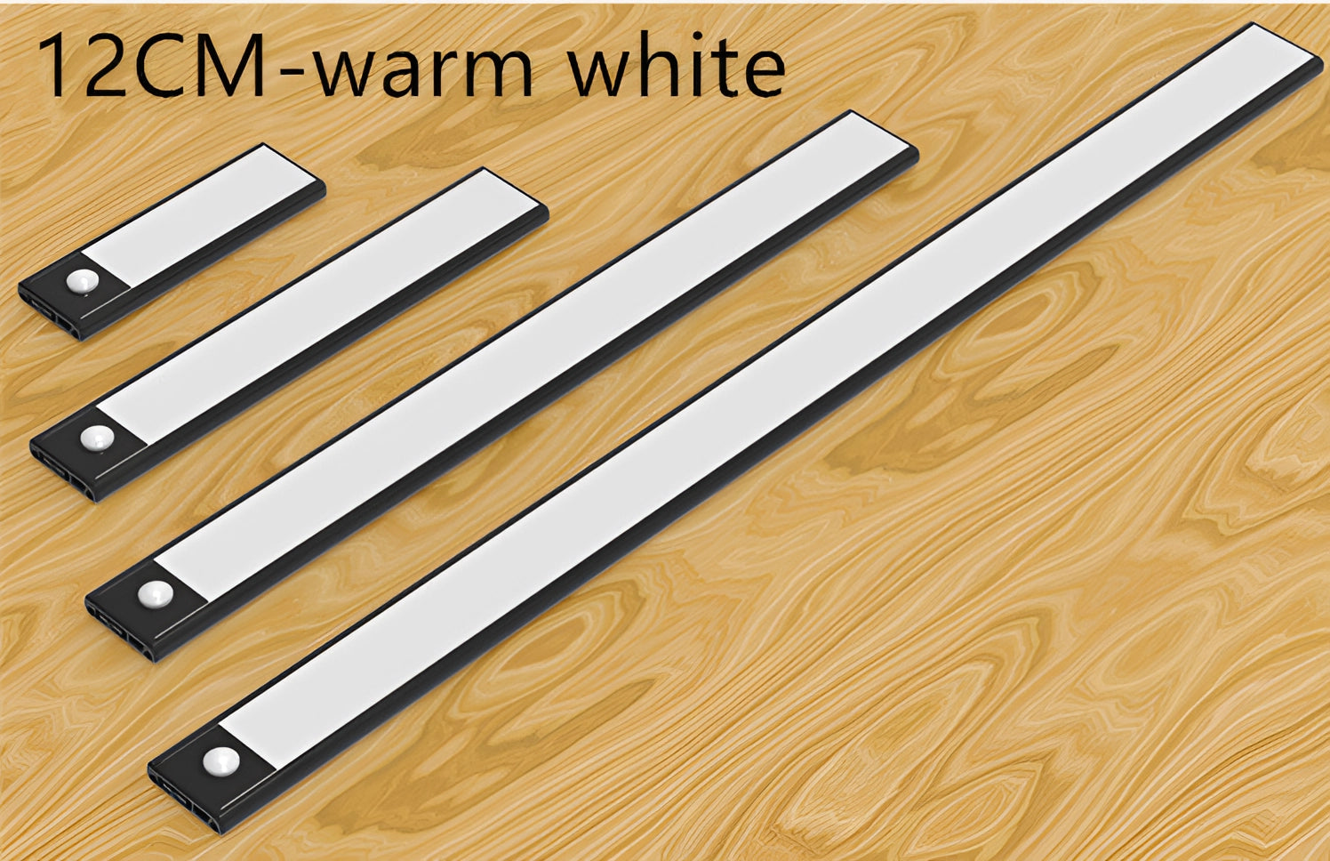 12CM Magnetic Warm White LED Strip in black, mounted underneath a modern kitchen cabinet providing warm white illumination on a wooden surface.