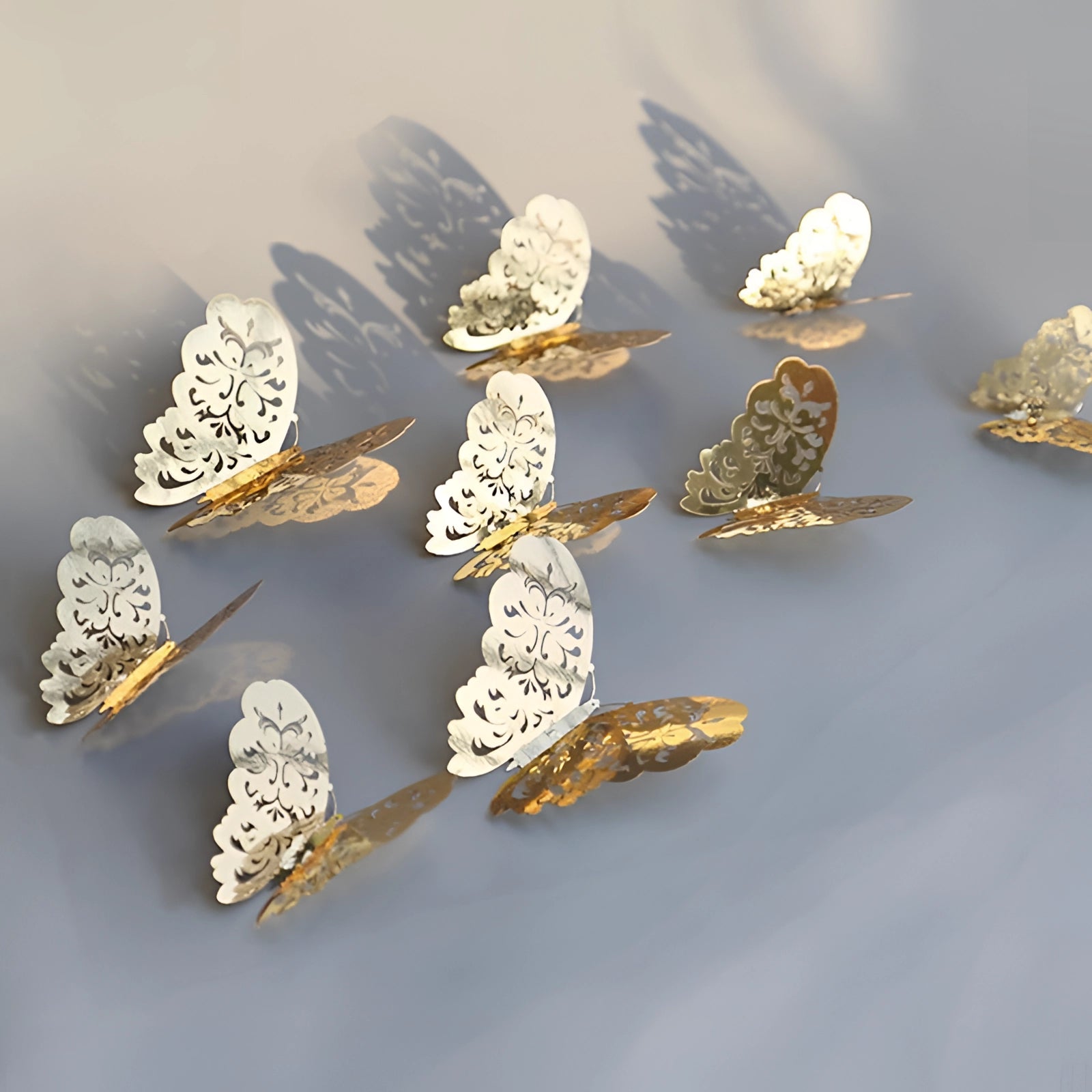 3D gold butterfly wall art featuring luxurious metallic butterfly sculptures delicately designed and intricately detailed against a backdrop resembling twigs and plant elements.