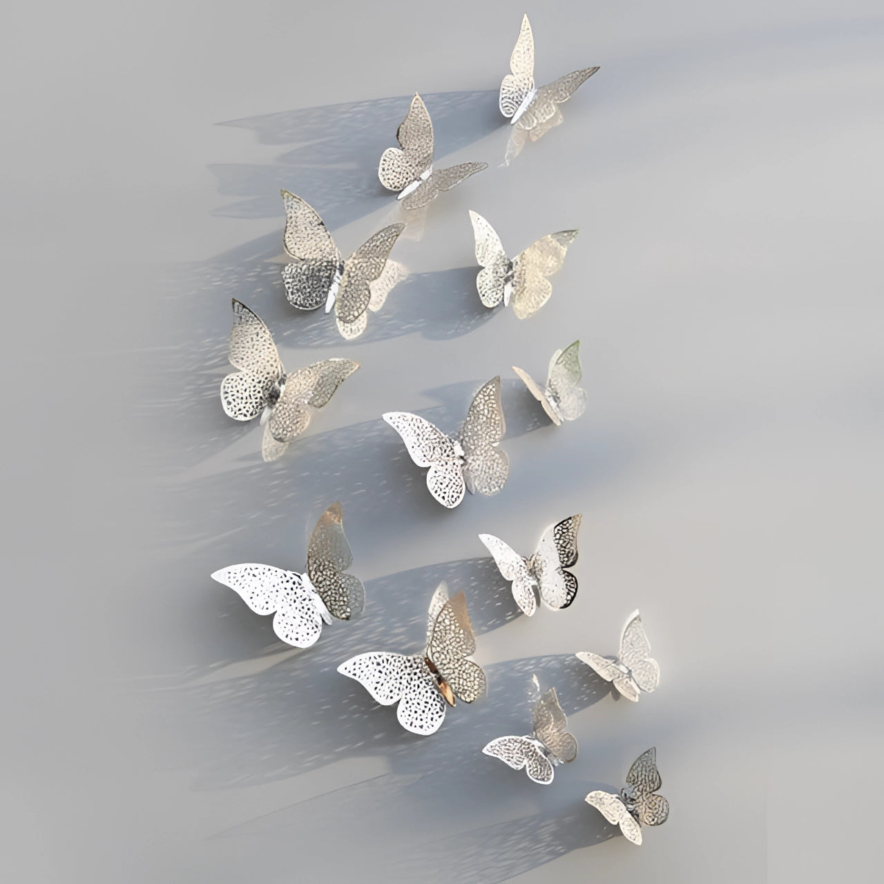 Silver 3D butterfly wall art with detailed metallic wings, featuring intricate patterns and a twig-like body for luxury decor.