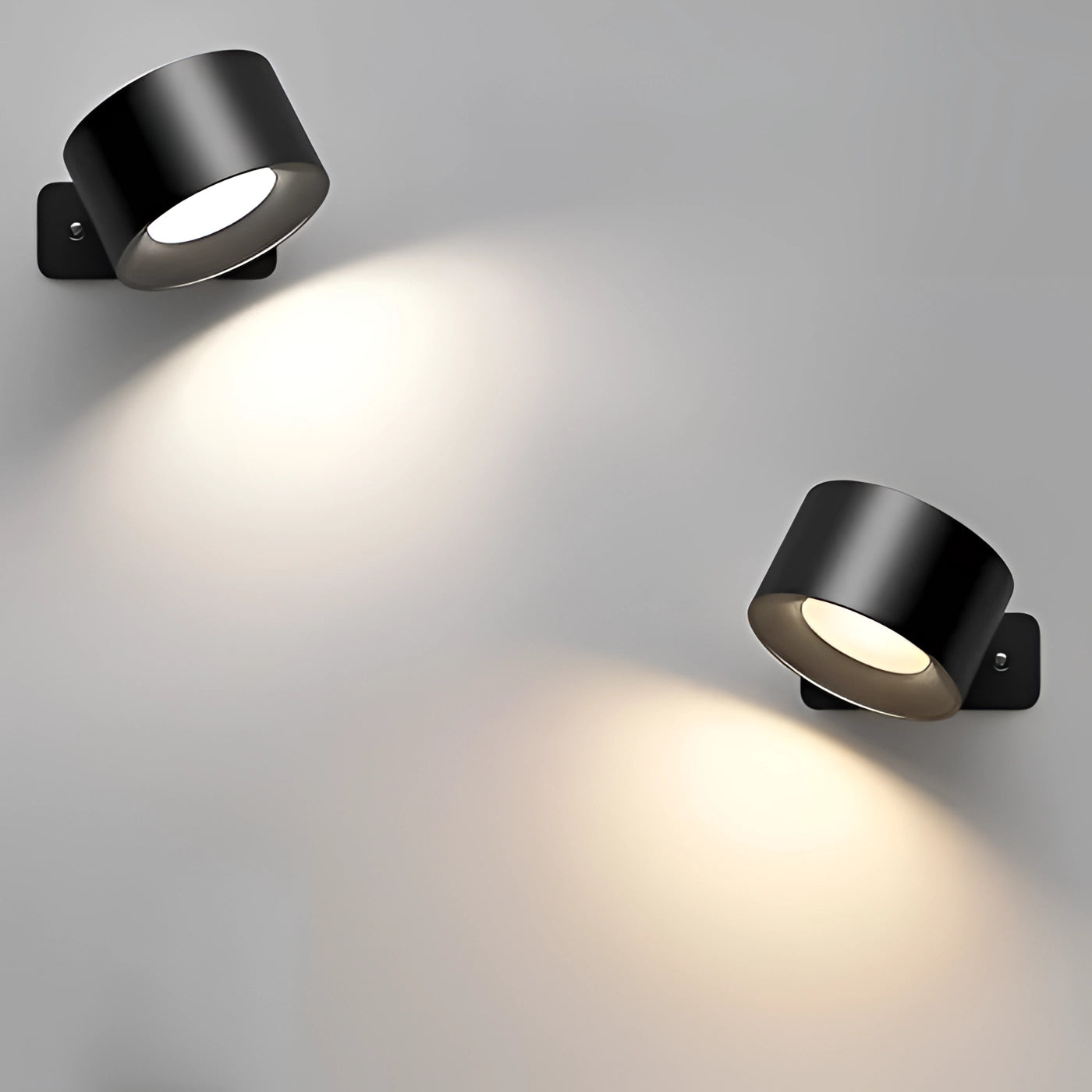 Black and white geometric wall decor with integrated wireless lighting, featuring abstract patterns and cylindrical elements against a minimalist backdrop.