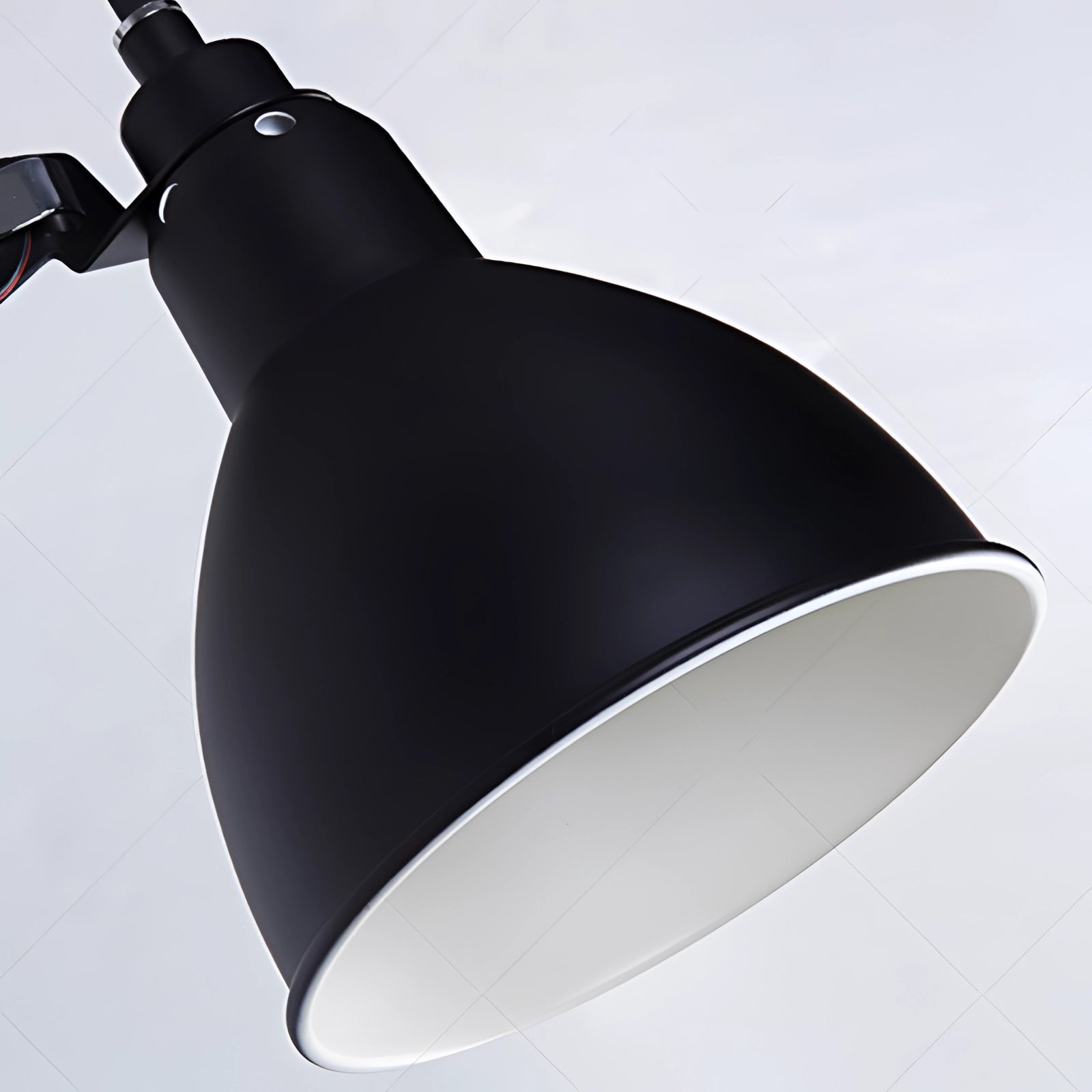Adjustable black metal wall lamp with an industrial design, featuring an LED sconce and a lampshade.