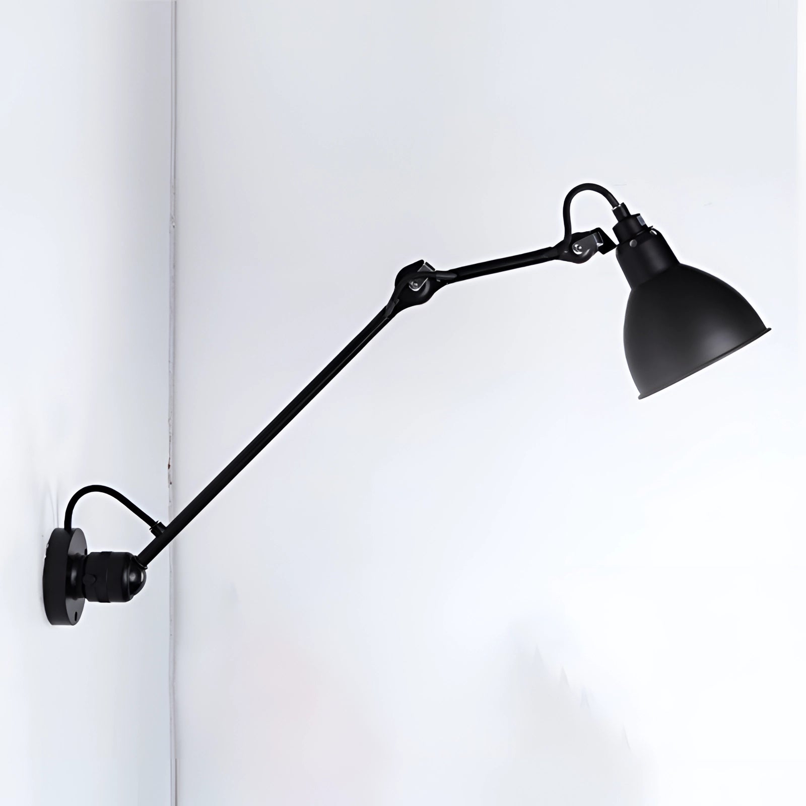 Adjustable black metal wall lamp with an industrial design, featuring an LED sconce style light fixture against a monochrome background.