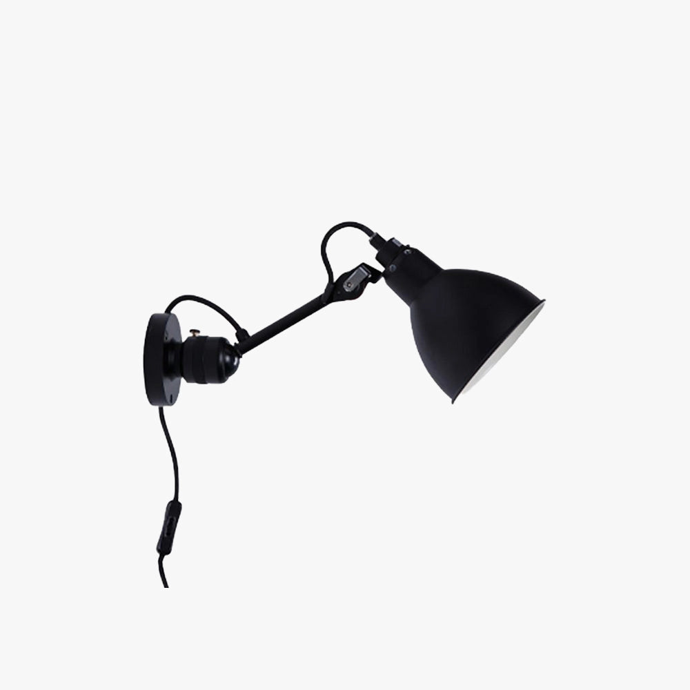 Adjustable black metal wall lamp with an industrial design featuring a LED sconce, mounted on a wall in a minimalistic setting.