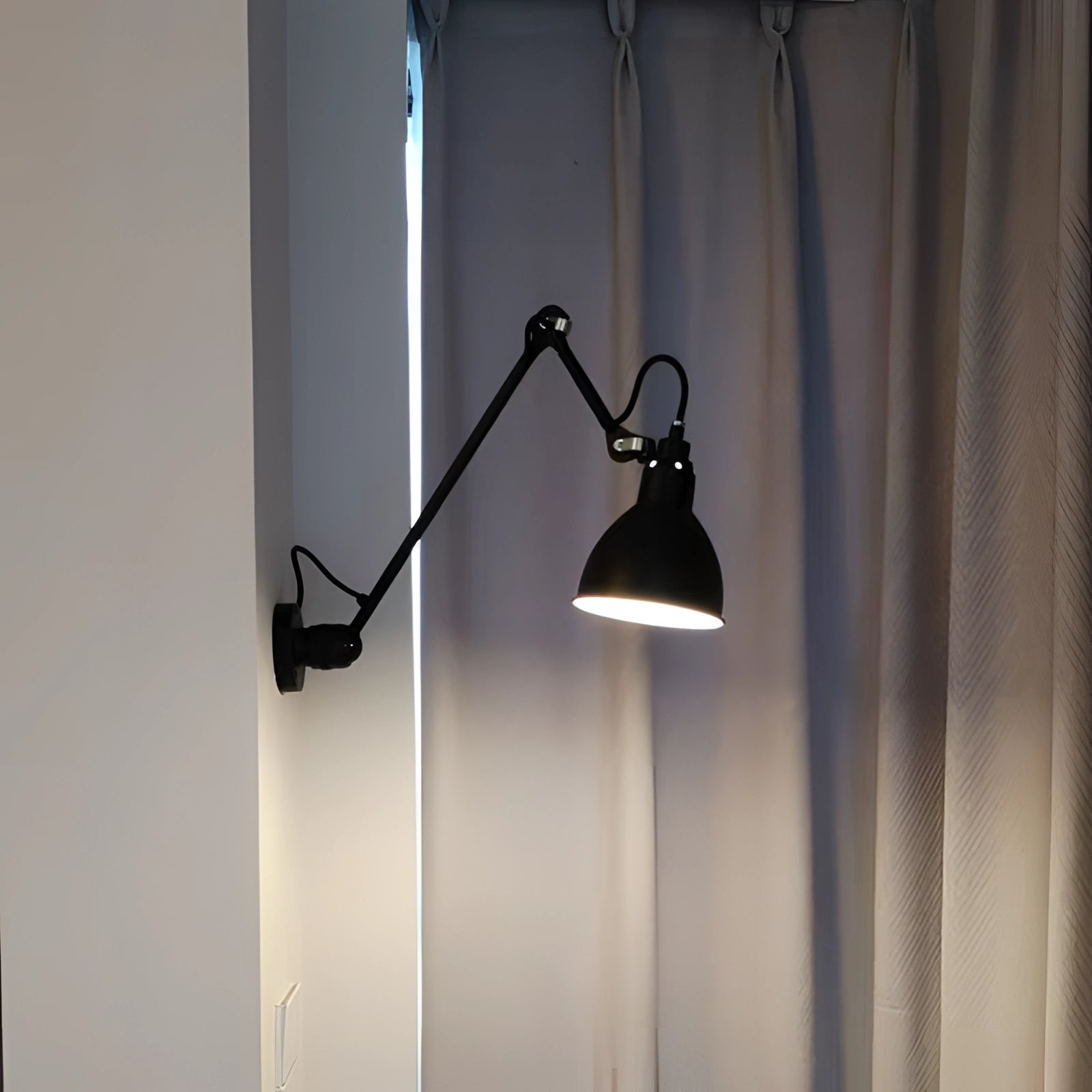 Adjustable black metal wall lamp with industrial design, featuring a 23.5-inch LED sconce and a sleek lampshade, mounted on a wall with a wood panel background.