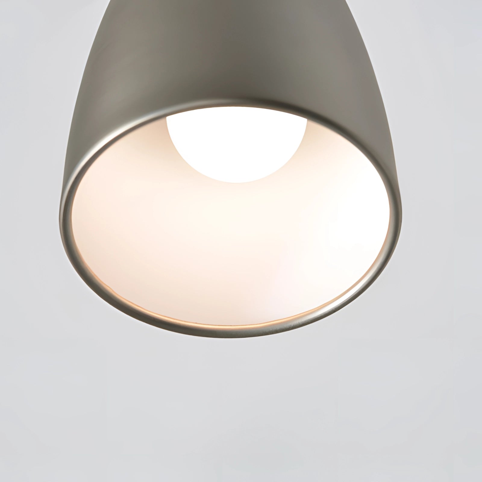 Adjustable black wall lamp with industrial design, featuring a flexible arm and metal lampshade, mounted against a wooden backdrop.