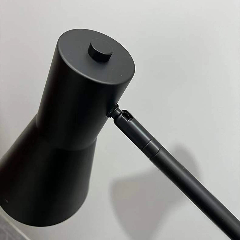 A stylish adjustable Nordic floor lamp featuring a sleek black and gold design, with a cylindrical shade and a sturdy metal base, perfect for illuminating modern home interiors.
