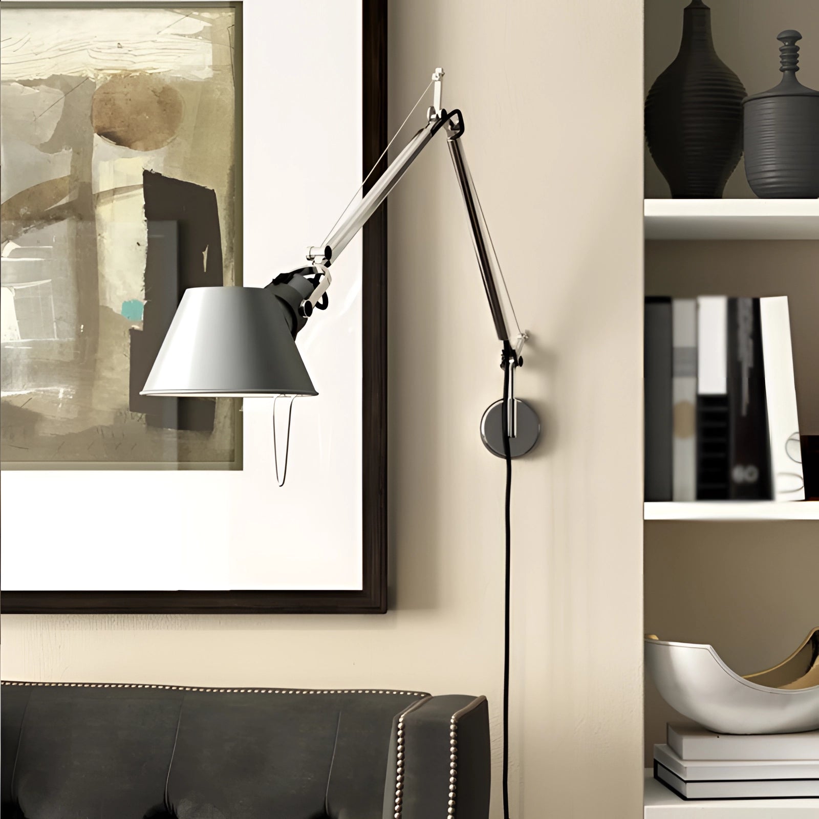 Adjustable wall-mounted metal lamp in an industrial style with a silver finish, featuring a rectangular shade, mounted on a wooden wall in an interior setting.