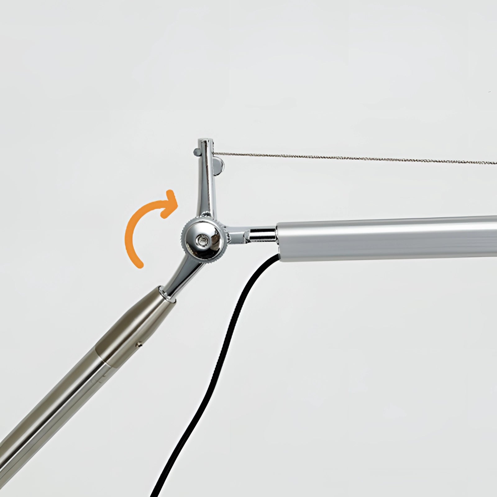 Adjustable wall-mounted metal lamp with an industrial design, featuring a sleek metallic finish and wiring, suitable for reading and ambient lighting.