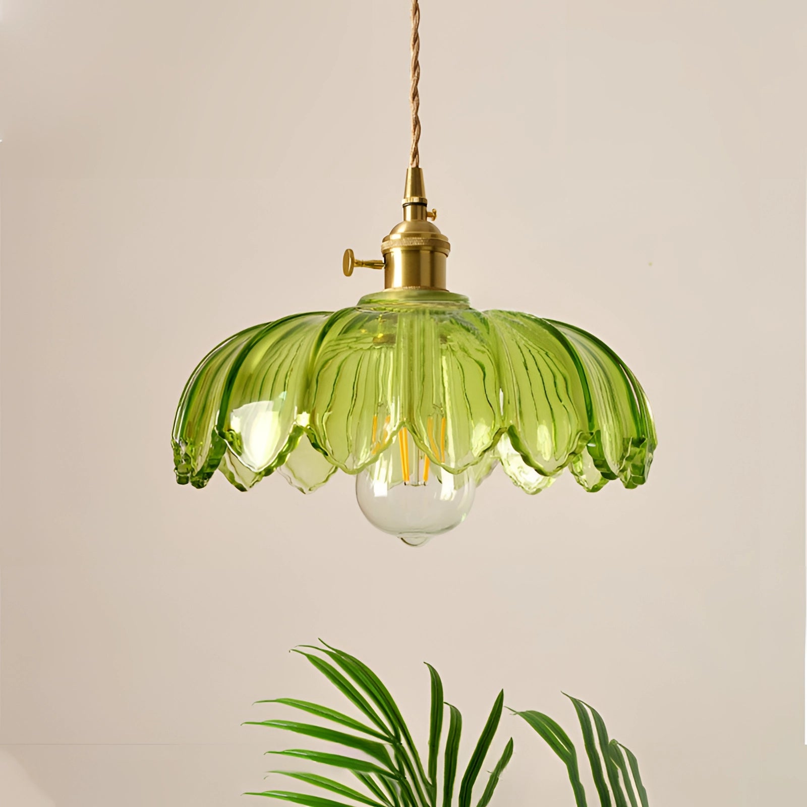 Amber glass floral pendant light with vintage brass chandelier, featuring a green tint and measuring 25 x 20 cm, elegantly designed with a floral motif resembling petals, suspended as a ceiling fixture in an interior setting.