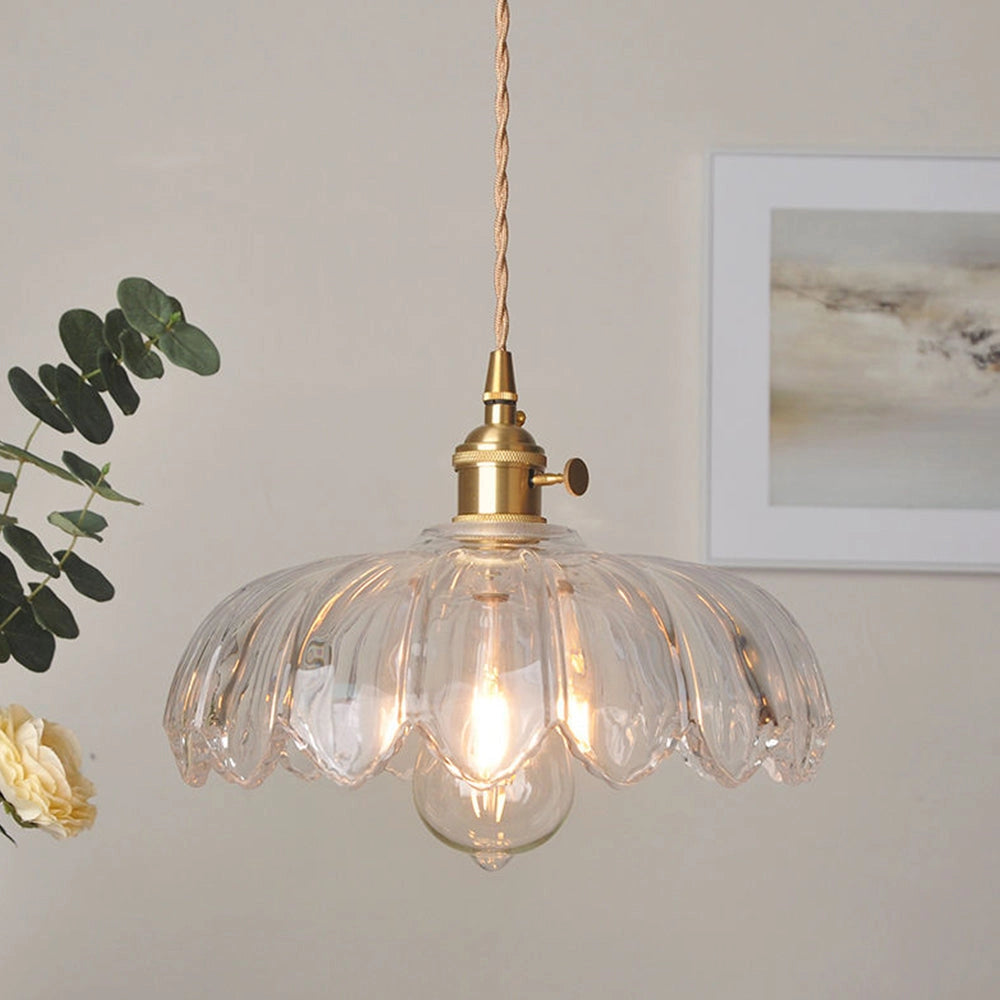 Amber glass floral pendant light with a vintage brass finish, featuring a transparent design measuring 25 x 20cm, hanging from the ceiling. The chandelier incorporates natural materials, showcasing twig-like ornamentation and a light bulb, with a warm amber tint.