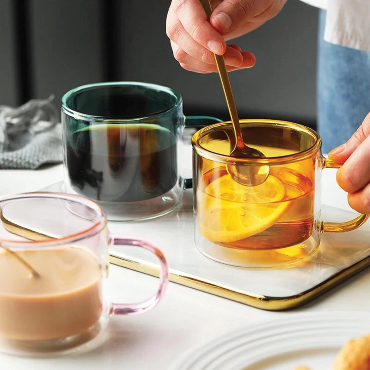 Amber glass mug used for serving coffee or tea, showcasing its durable and heat-resistant properties, placed on a table setting.