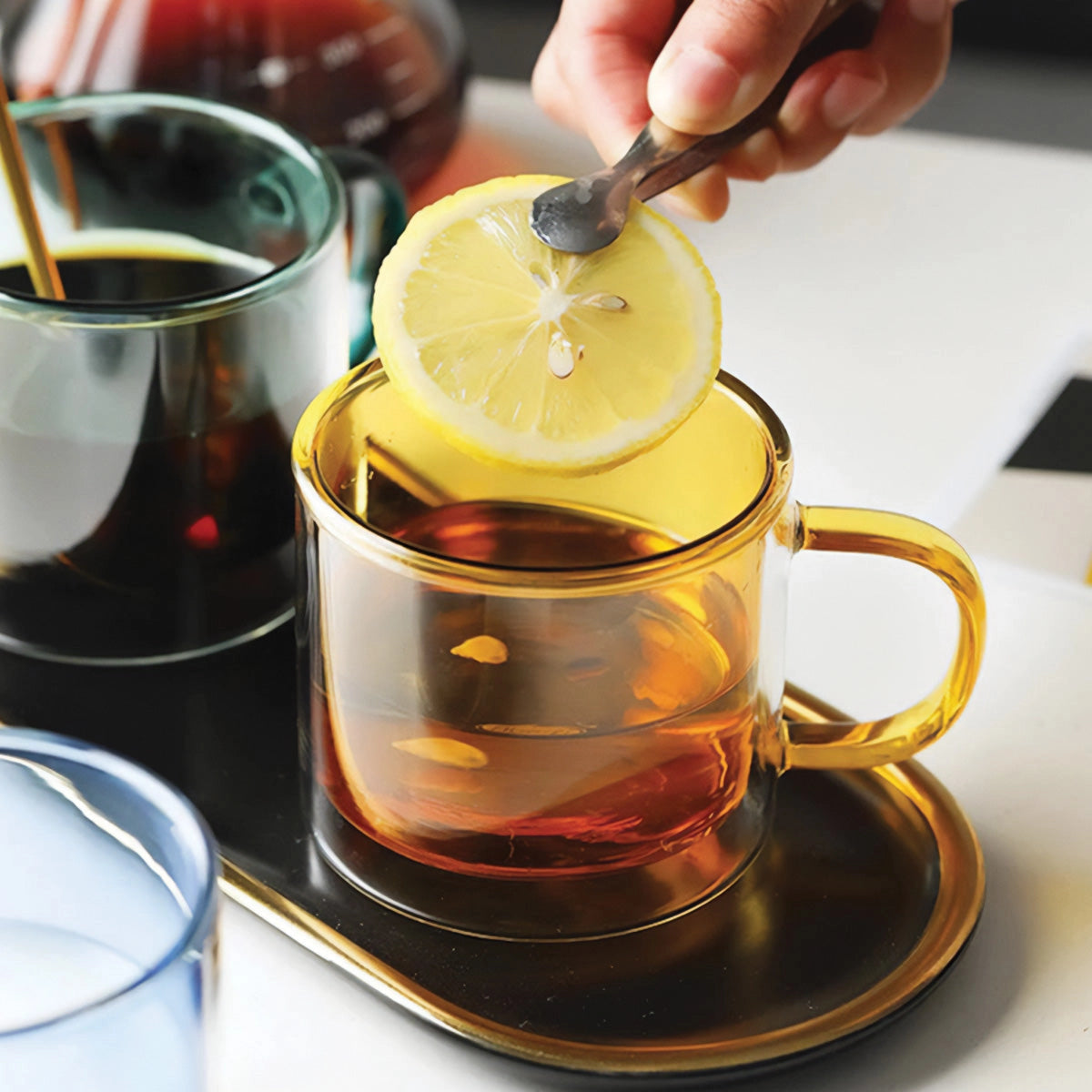 Amber glass mug filled with a hot beverage, showcasing its durable and heat-resistant design, ideal for coffee and tea, placed on a table.