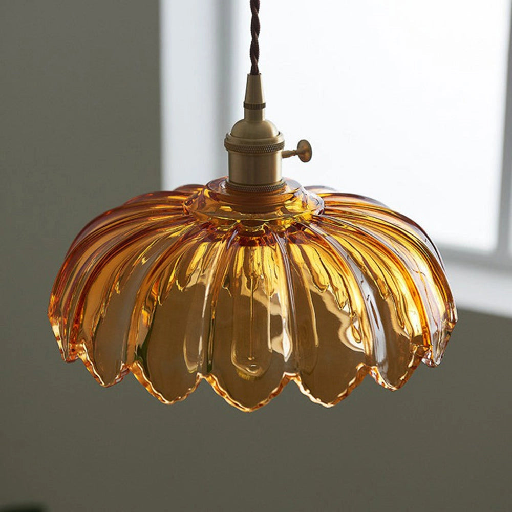 Amber Glass Pendant Light with Vintage Flower Design and Antique Brass Finish, featuring a symmetrical circular ornament.