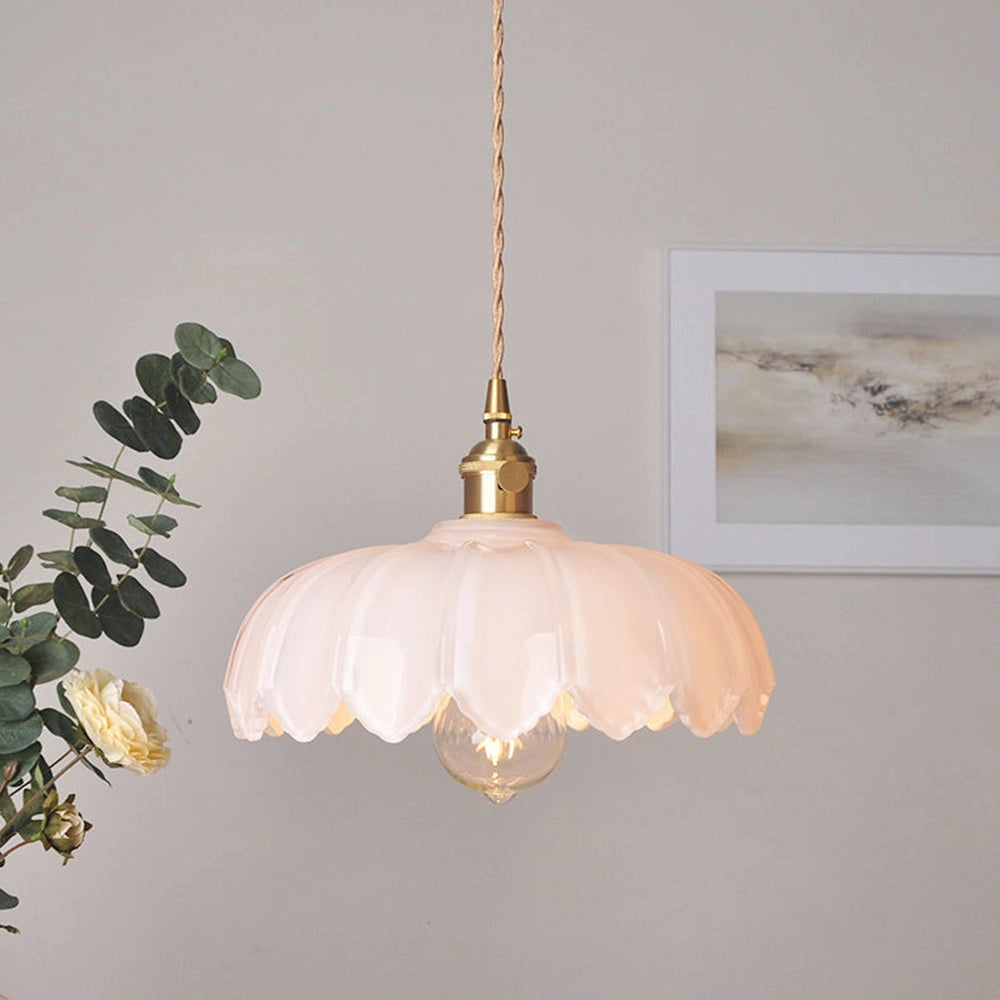 Amber glass pendant light with vintage flower design, antique brass finish, and dimensions D25 x H20cm, hanging from ceiling.