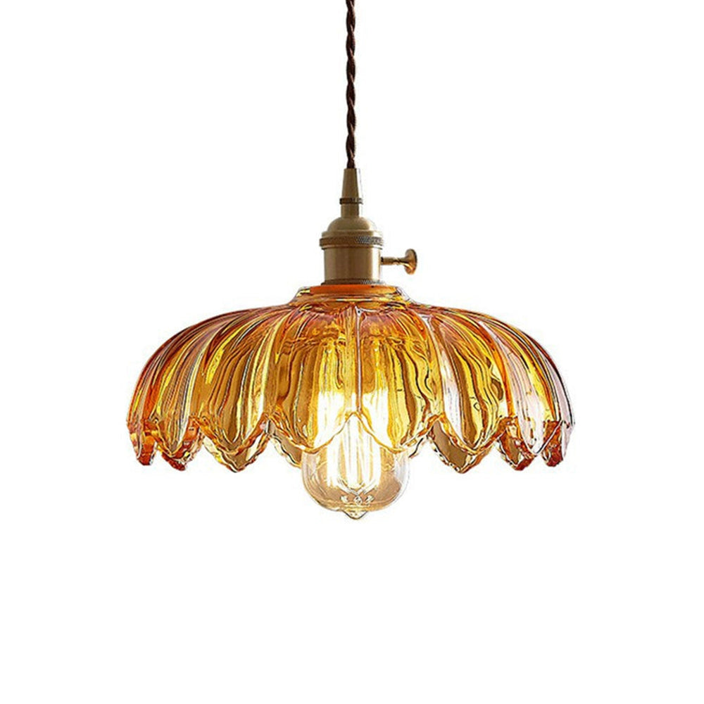 Vintage amber glass pendant light with antique brass finish, featuring a flower design and ceiling fixture.