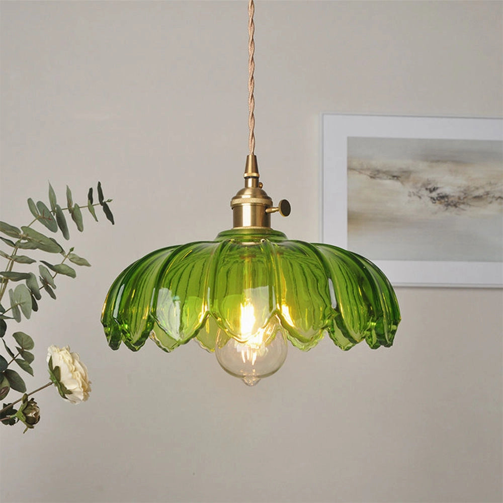 Vintage flower-inspired amber glass pendant light with antique brass finish, green variant, dimensions 25cm diameter by 20cm height, featuring intricate detailing and hanging from ceiling fixture.
