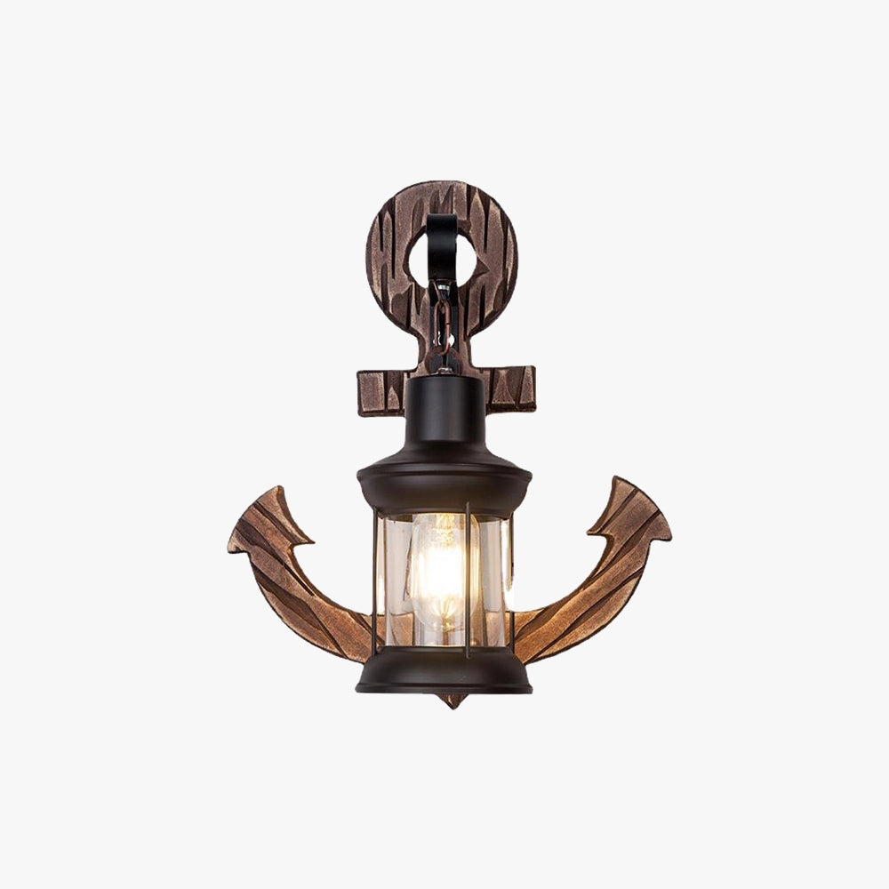 Anchor-shaped nautical wall sconce with rustic coastal design featuring a metal light fixture and bulb.