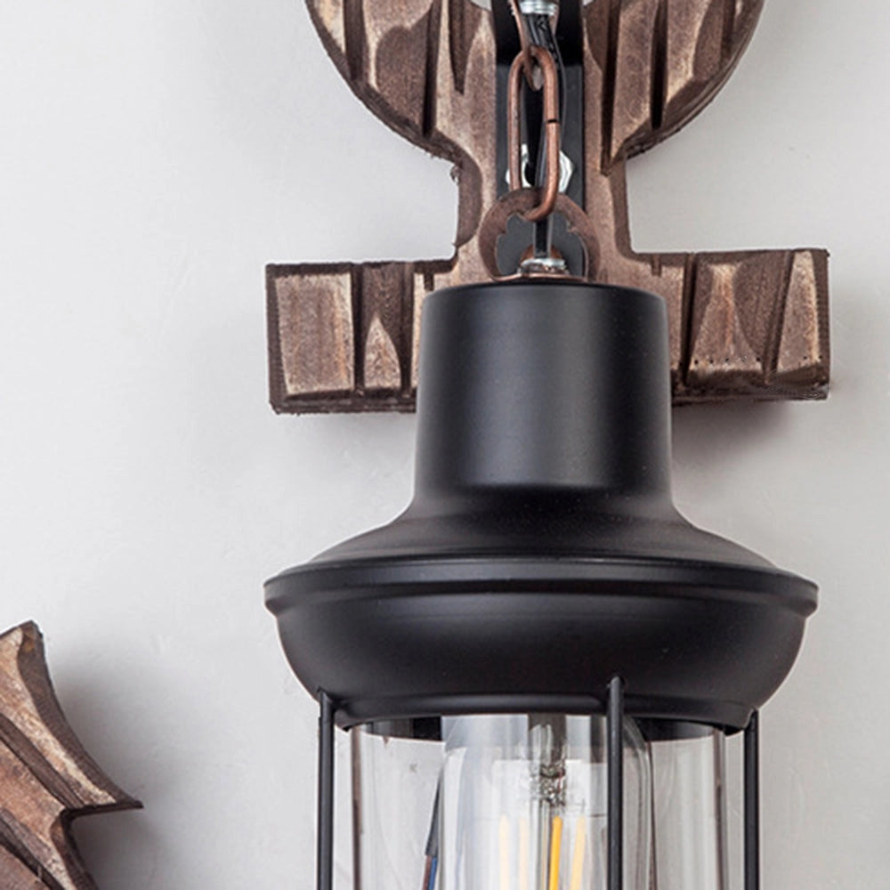 Anchor-shaped wall sconce with a rustic coastal design, featuring a combination of wood and metal materials, providing a nautical theme with its unique anchor symbol and decorative light fixture.
