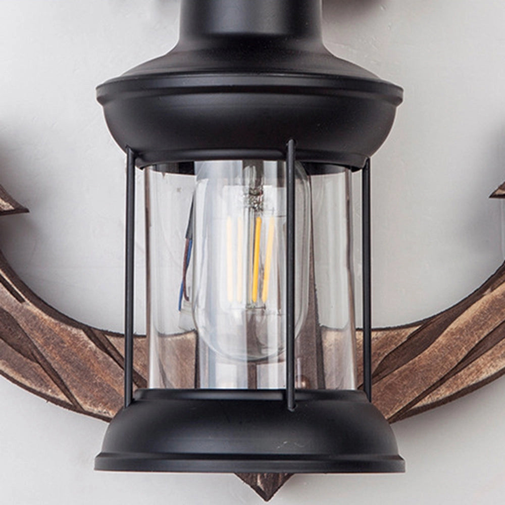 Anchor-shaped nautical wall sconce with a rustic coastal design, featuring a metal and glass construction that resembles a classic maritime style.