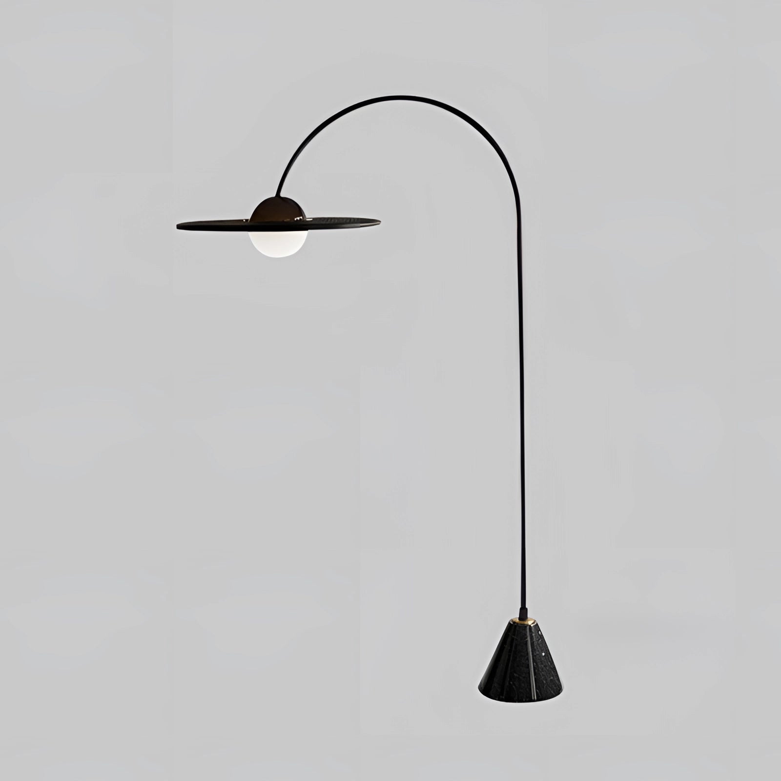 Modern black arched minimalist floor lamp with a sculptural design, featuring a sleek and elegant appearance, suitable for contemporary home decor.