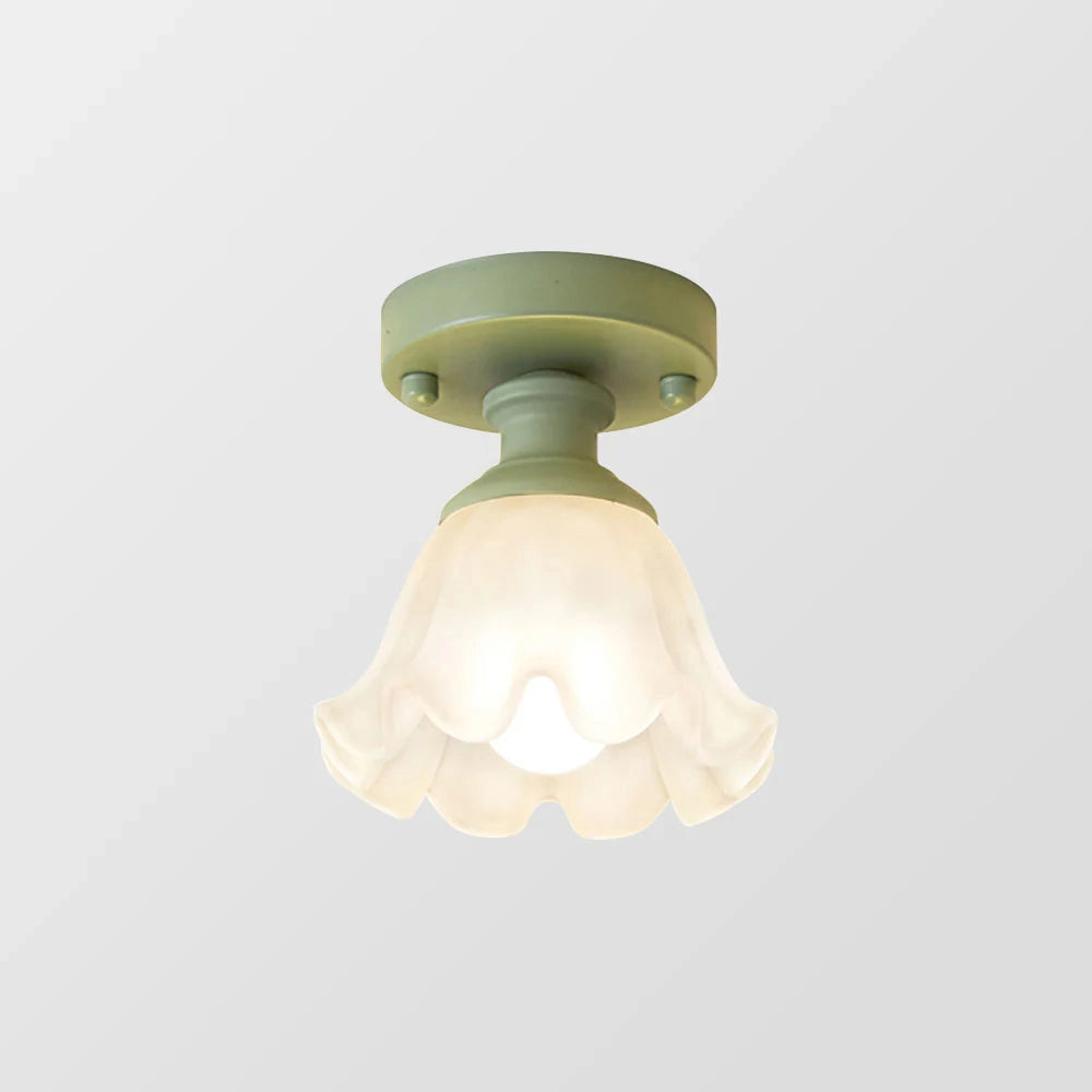 Art Nouveau vintage flush mount light featuring a tulip-shaped glass lampshade and a brass fixture, designed for ceiling installation.
