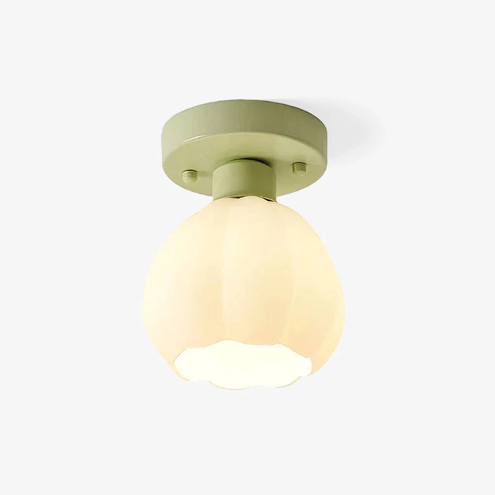 Art Nouveau vintage flush mount light featuring a tulip-shaped glass and brass fixture, elegantly mounted on a ceiling, with intricate details and a circular design.