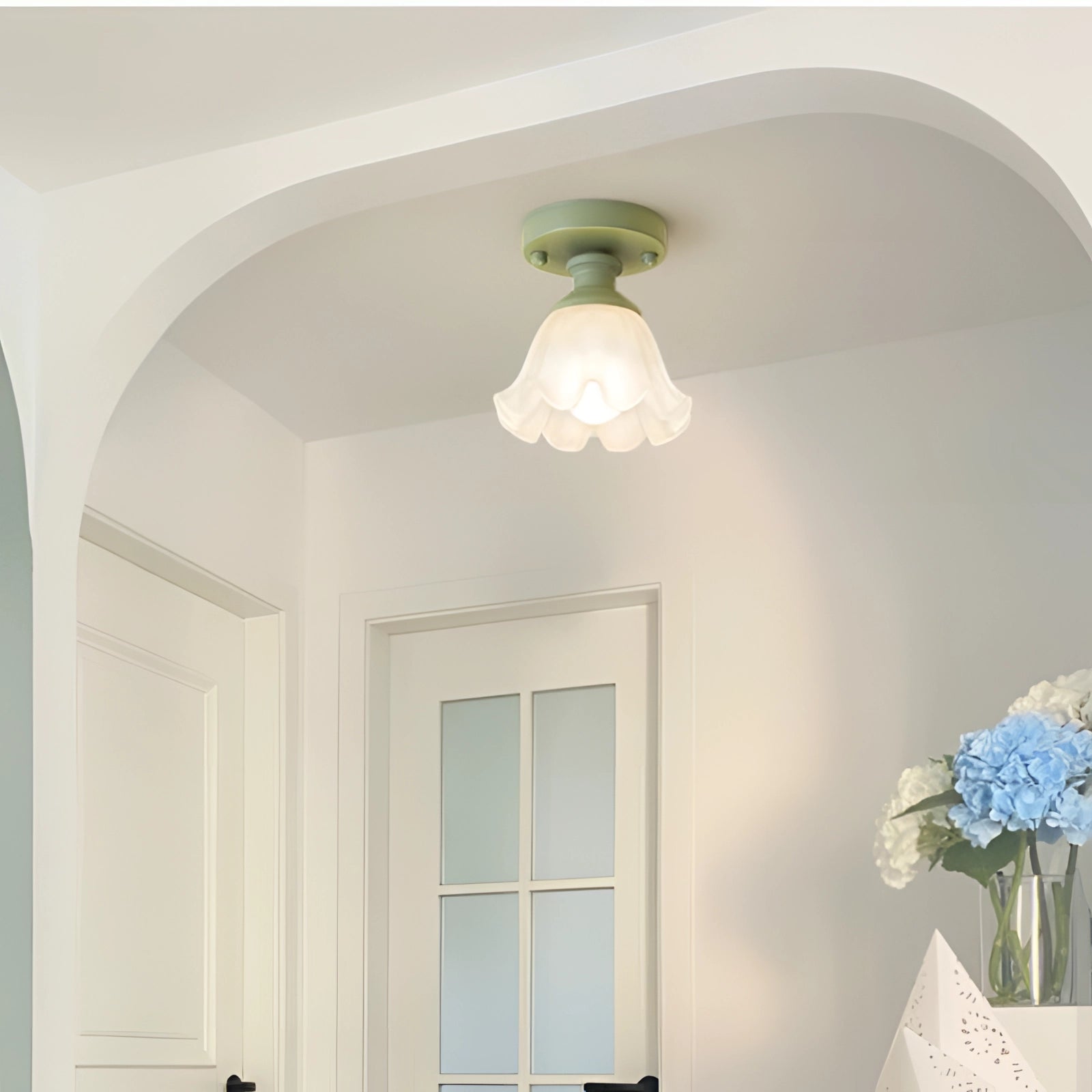 Art Nouveau Vintage Flush Mount Light featuring a tulip-shaped glass shade and brass fixture, mounted on a ceiling in an elegantly designed interior space with wooden elements and plaster molding.