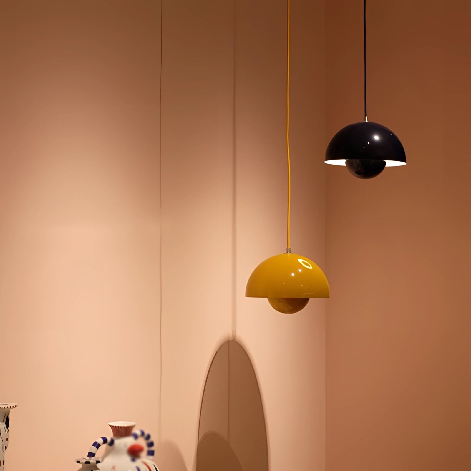 Modern retro pendant lights in yellow, white, and orange colors, featuring a circular design and wooden accents, hanging from a ceiling to enhance interior decor.
