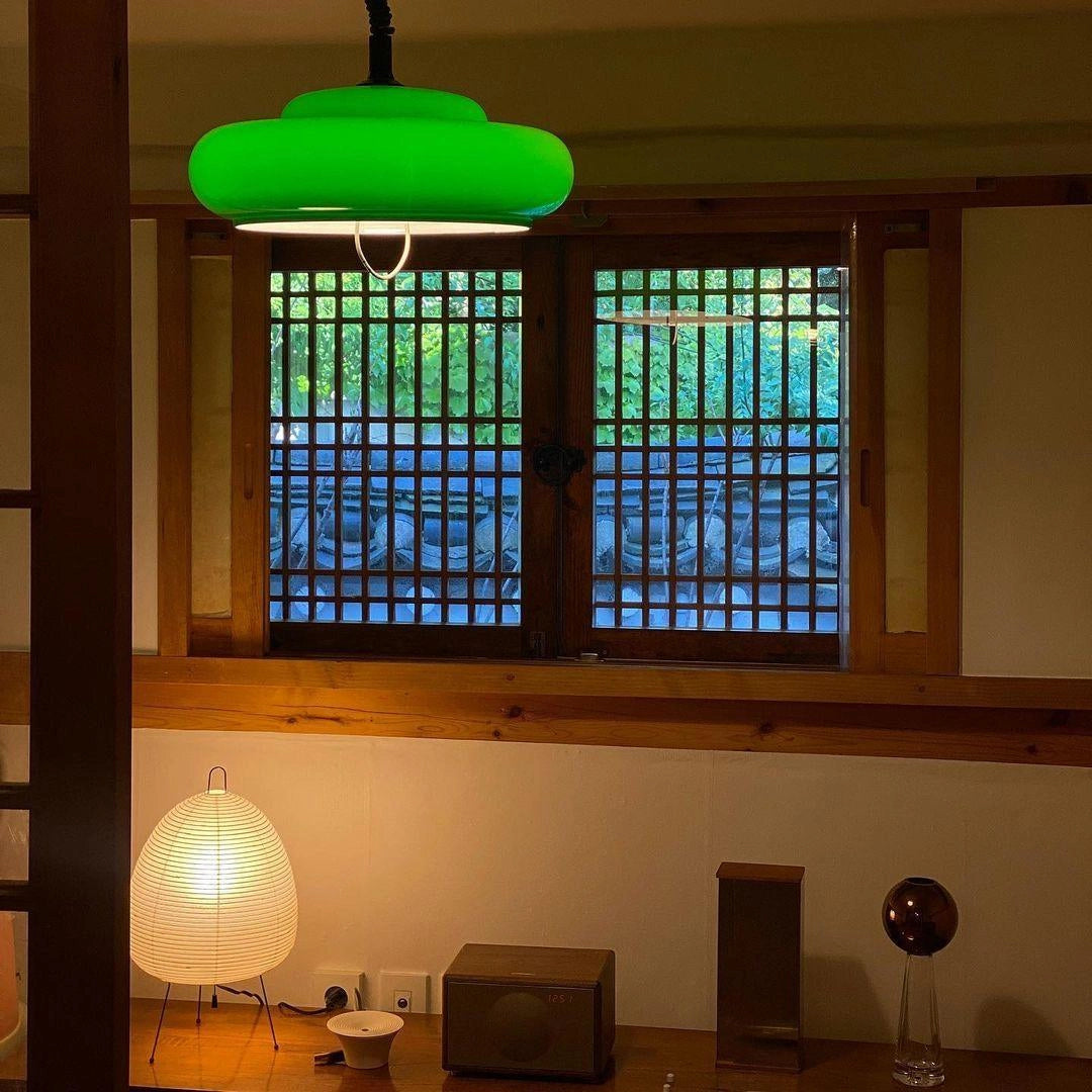 Beehive Sculptural Tripod Floor Lamp with a unique shade design, placed in a stylish living room with hardwood floors and large windows, enhancing the interior design with its artistic light.