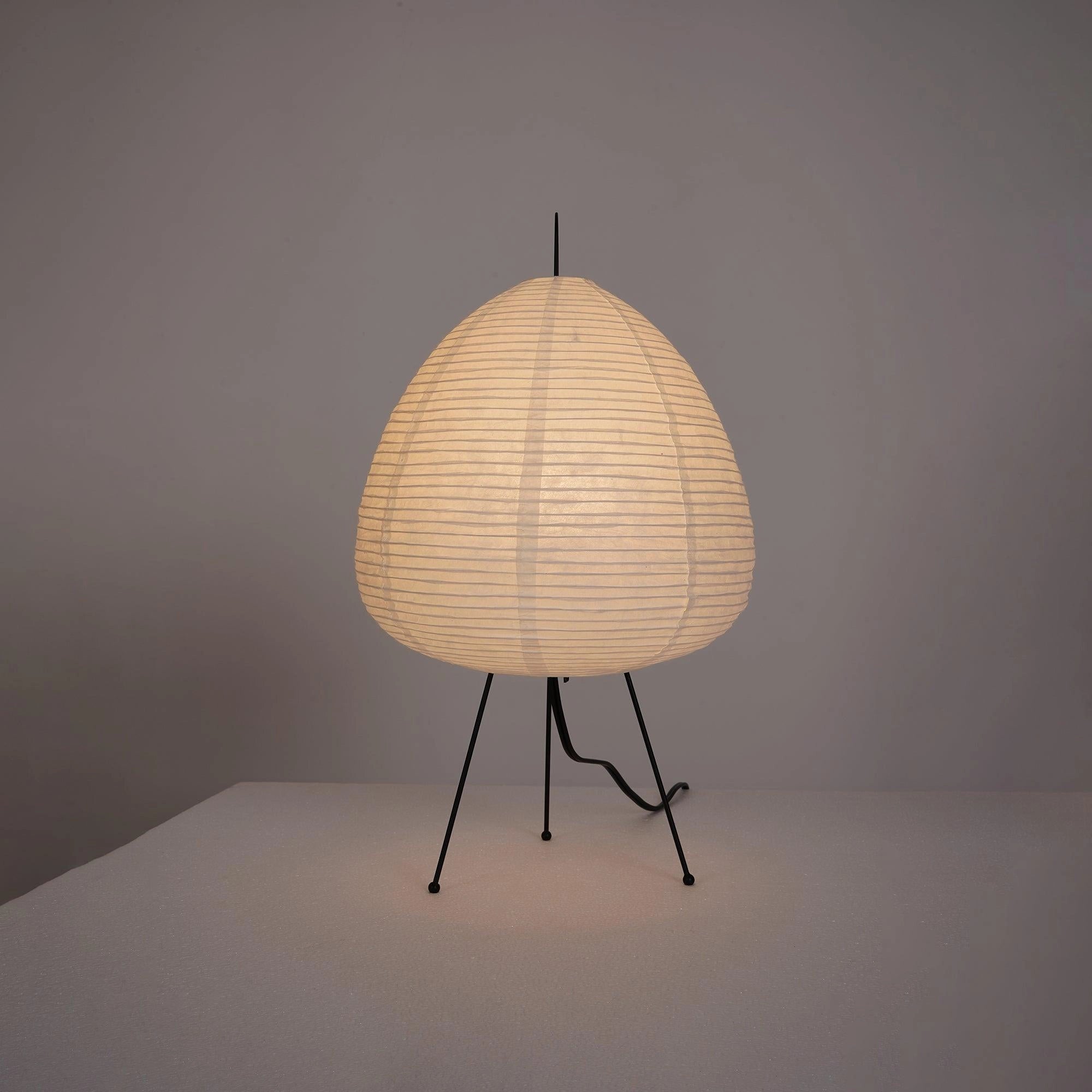 Unique Beehive Sculptural Tripod Floor Lamp with a circular wooden lampshade, standing on a sleek tripod base, designed as a statement piece in home decor.