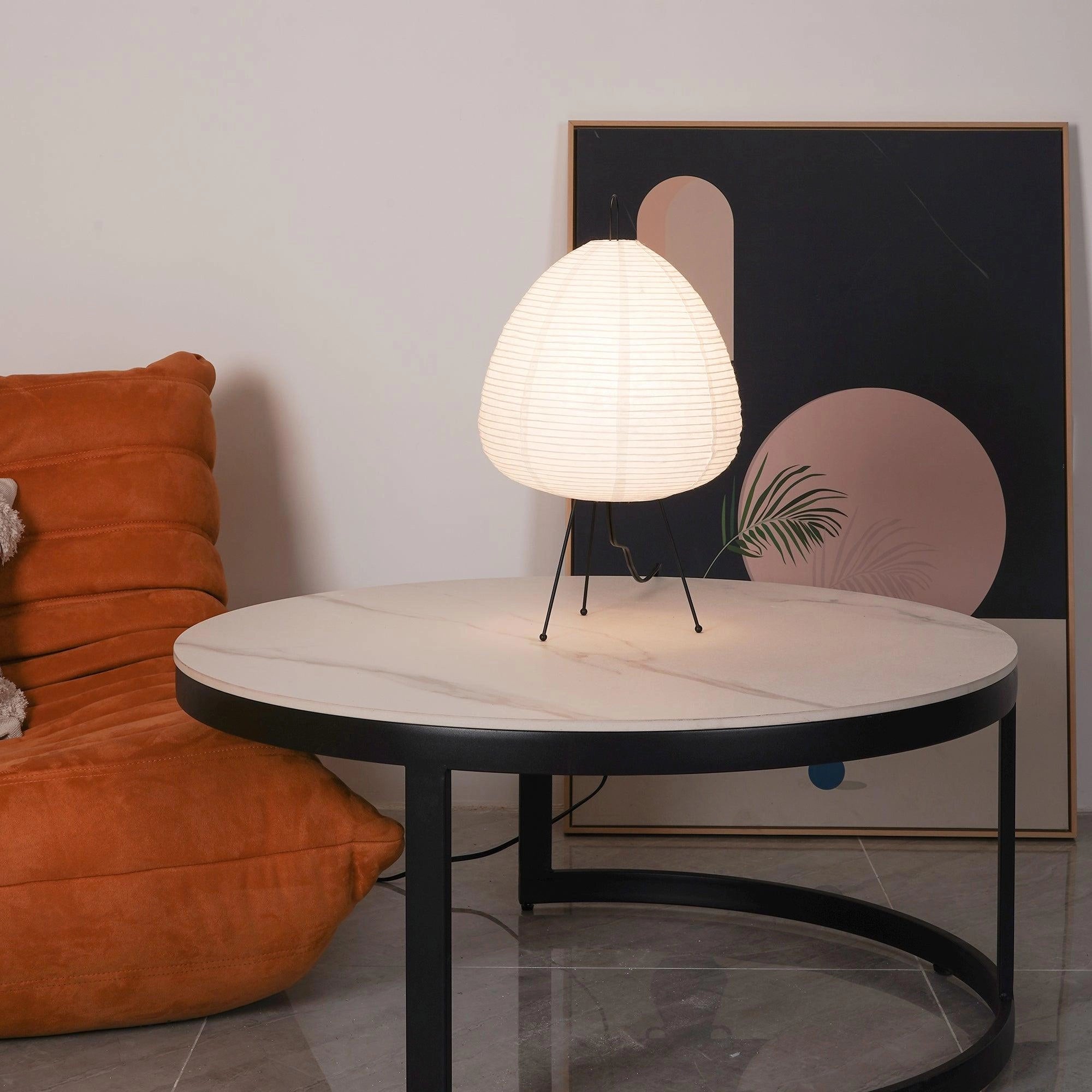 Unique sculptural tripod floor lamp with beehive design, placed in a stylish interior setting next to wooden furniture and a table.