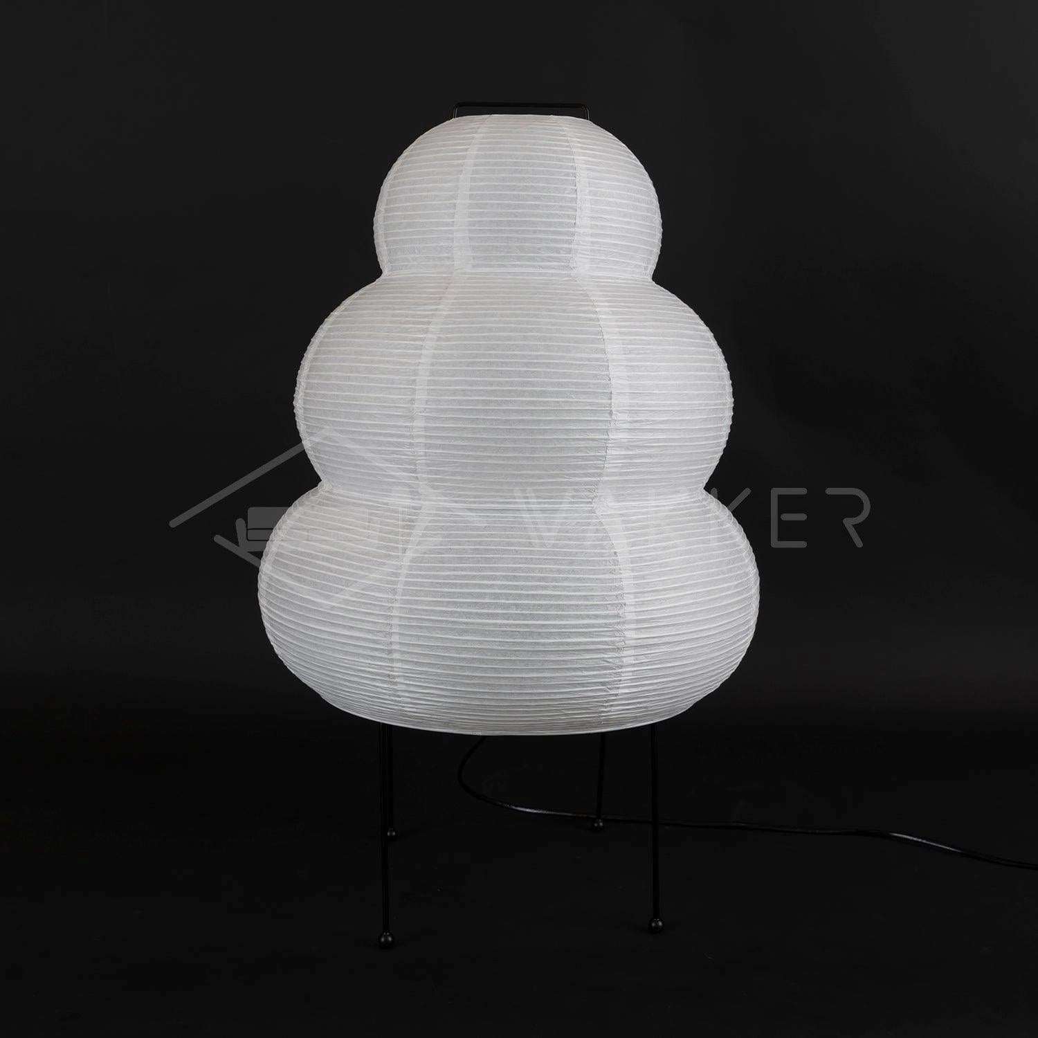 Unique Beehive Sculptural Tripod Floor Lamp with intricate symmetrical design and artistic pattern, standing in a dark room.
