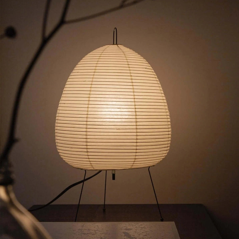 A unique sculptural tripod floor lamp with a beehive design featuring a wooden frame and amber-tinted circular shade, providing statement lighting for any room.