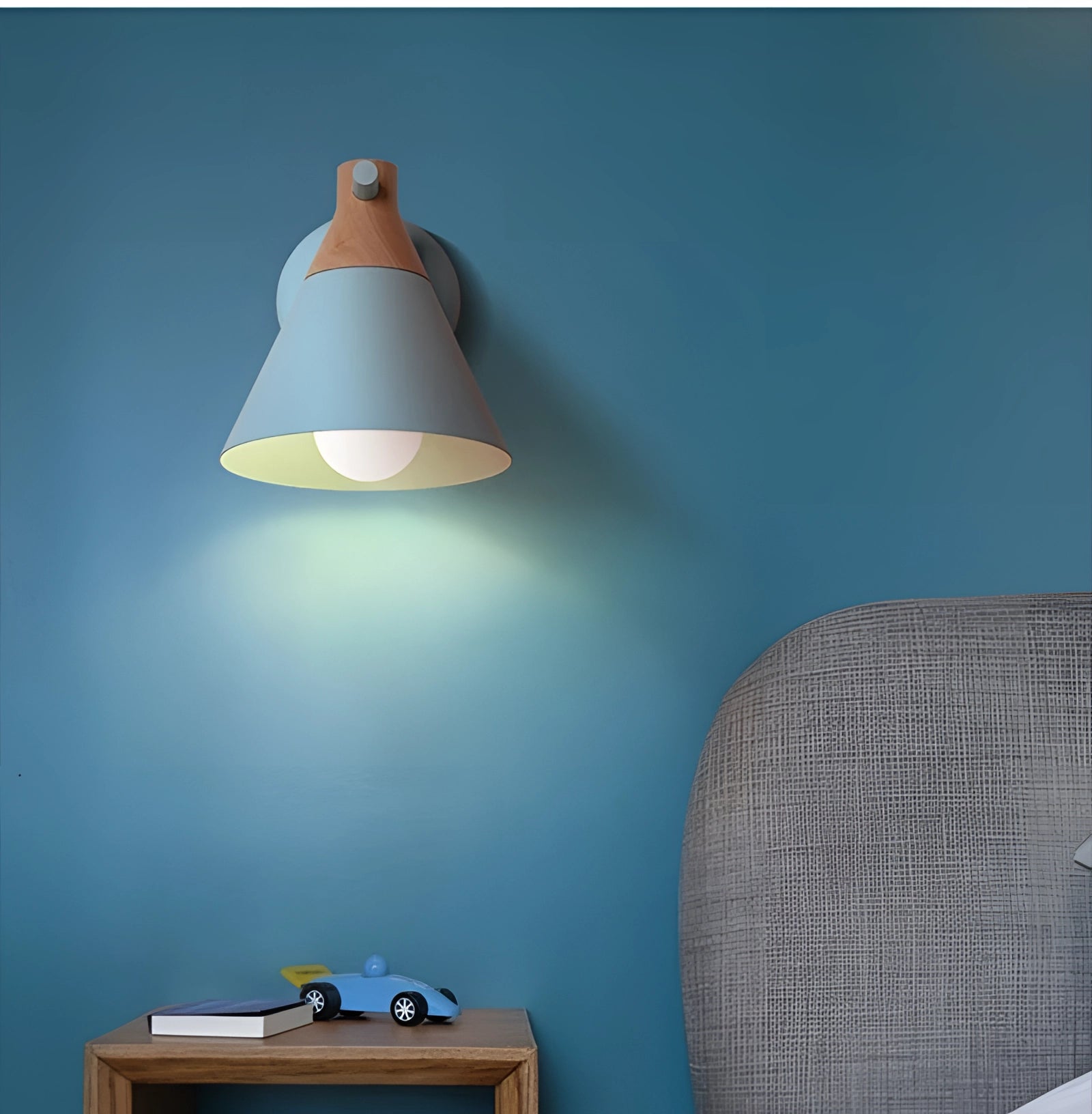 Beige adjustable LED wall lamp with a modern Nordic minimalist design, mounted on a blue wall above a wooden desk.