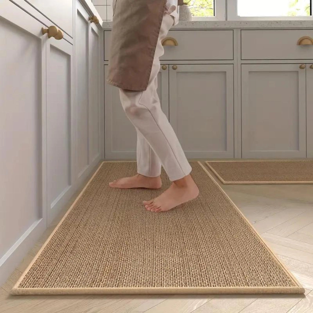 Beige anti-fatigue kitchen runner mat with a non-slip surface placed on a hardwood floor, featuring an 'Oats' color variant.