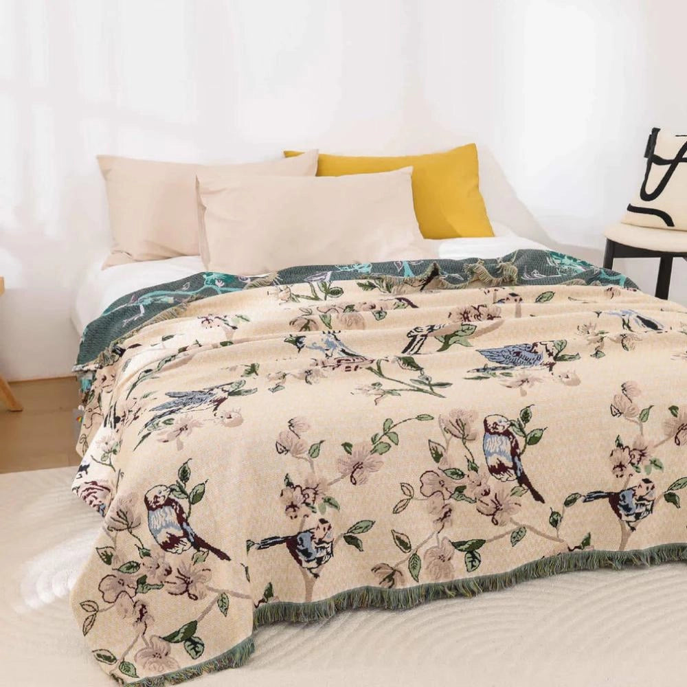 Nature-inspired bird-themed floral quilt displayed on a bed, featuring intricate botanical patterns with coordinating bed linens and pillows that emphasize a cozy, artistic, and inviting bedroom atmosphere.