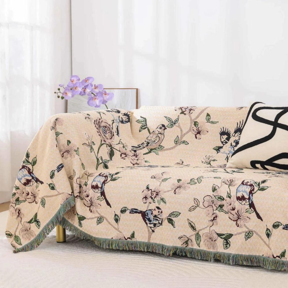 Bird-themed floral quilt featuring a botanical pattern with nature-inspired decor, showcasing intricate flowers and plant designs. The quilt has a rectangular shape and is laid out on a bed, highlighting its artistic and creative floral pattern.