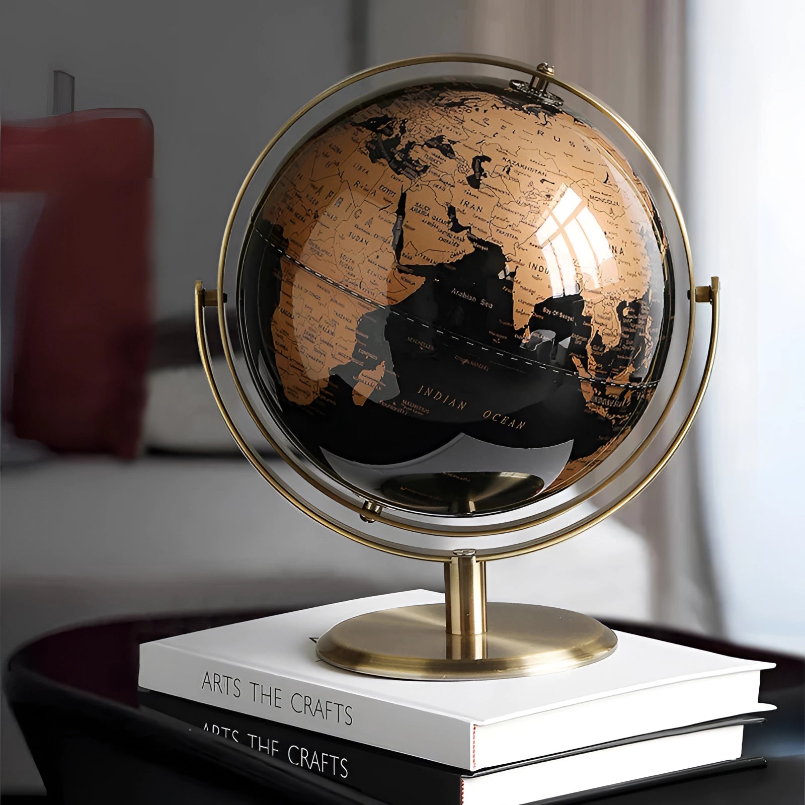Black cork globe with pins featuring a decorative world map, 24cm in diameter, showcasing countries and continents against a dark background.