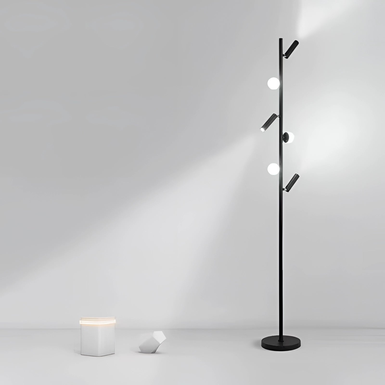 Black minimalist coat stand in a modern interior setting, featuring a sleek freestanding design with metal construction.