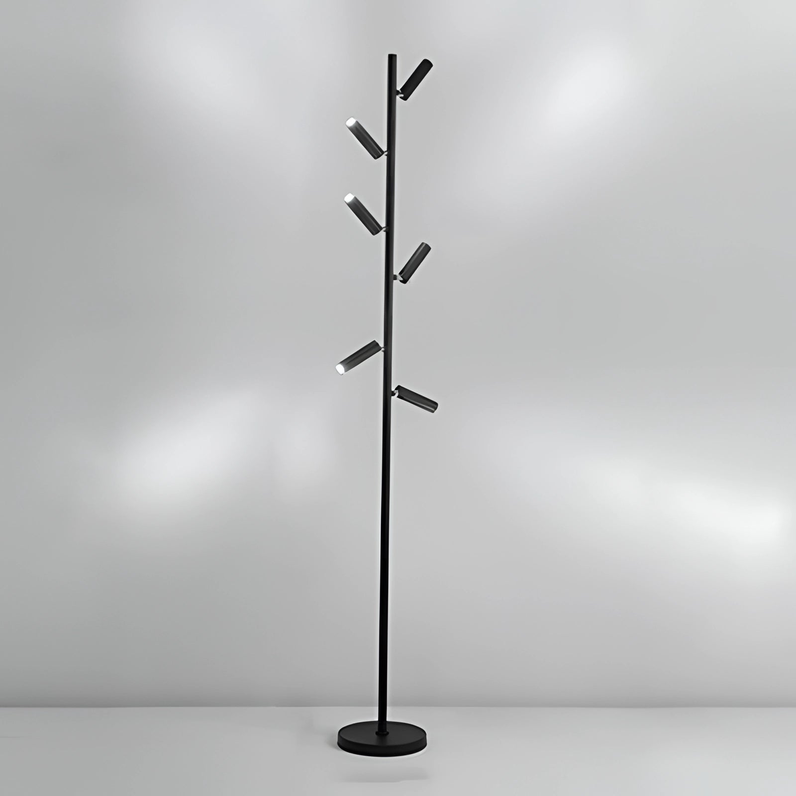 Modern black and white minimalist coat stand with six hooks, featuring a sleek freestanding design against a neutral background.