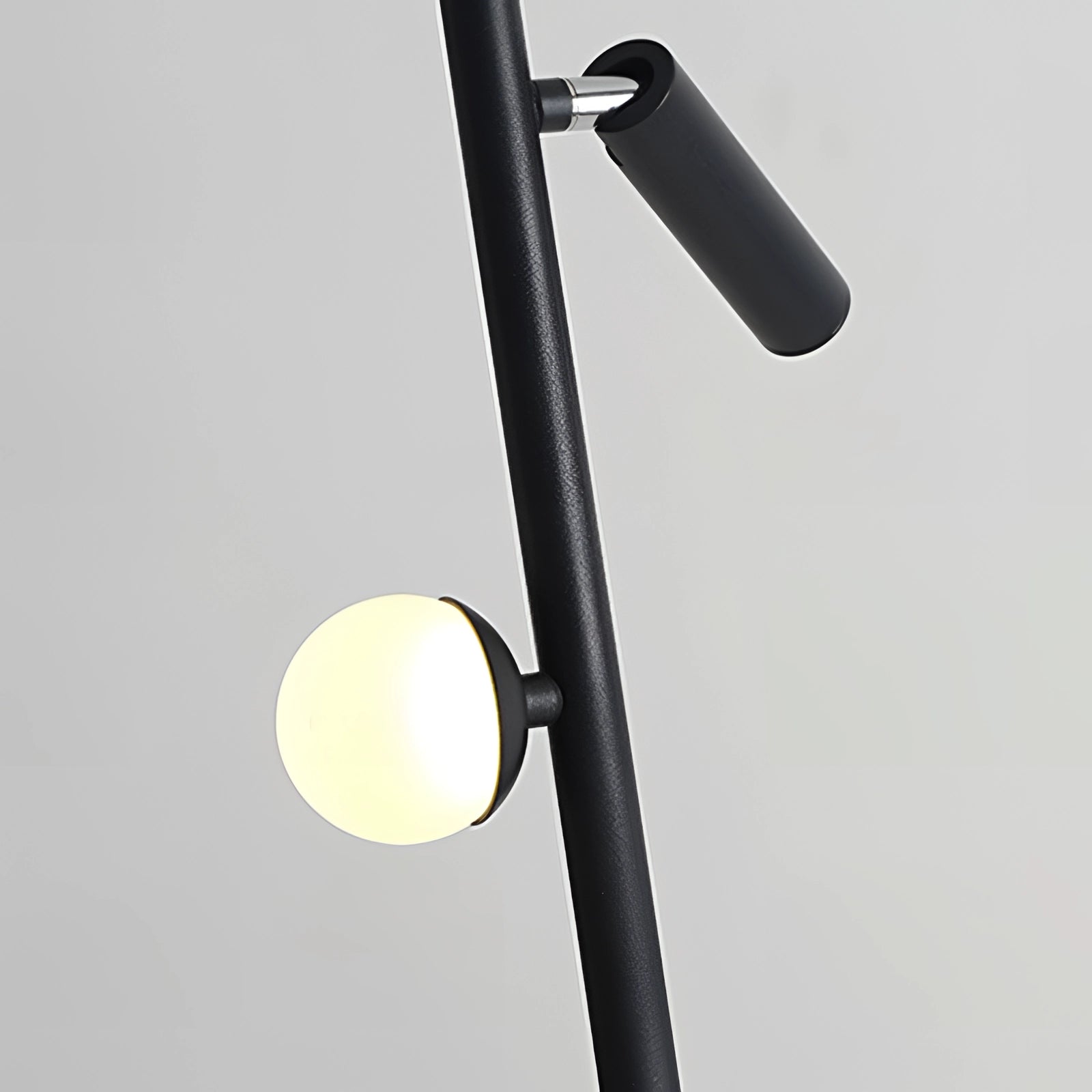 Black minimalist coat stand with a modern, sleek design, featuring a freestanding rack structure ideal for contemporary interior spaces.