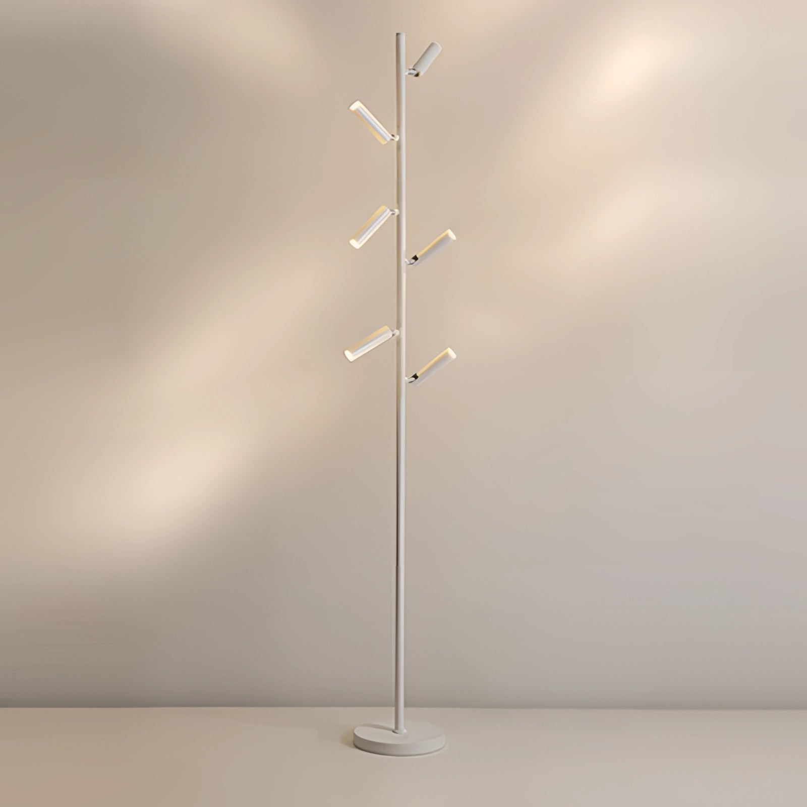 Minimalist coat stand in black and white with a sleek, modern design featuring six arms, illuminated by warm light, set against a stylish backdrop. 