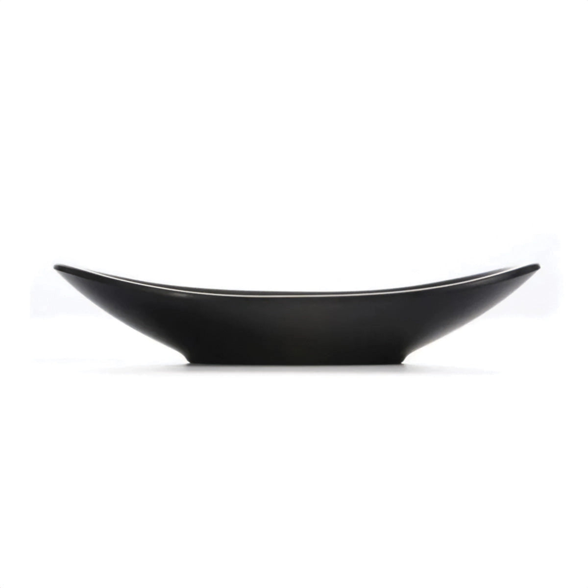 Black oval serving plates made of modern minimalist ceramic design, displayed on a table.